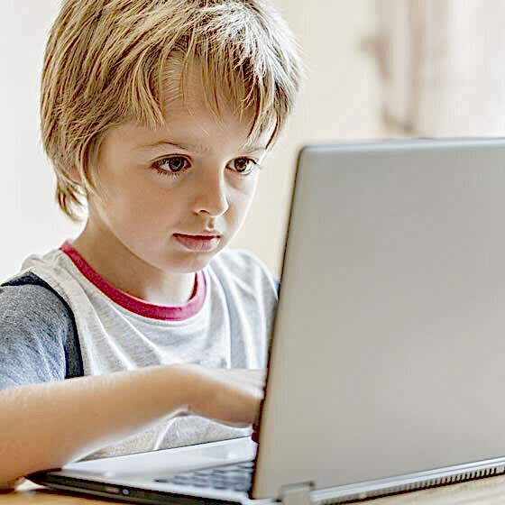 young-boy-working-on-laptop